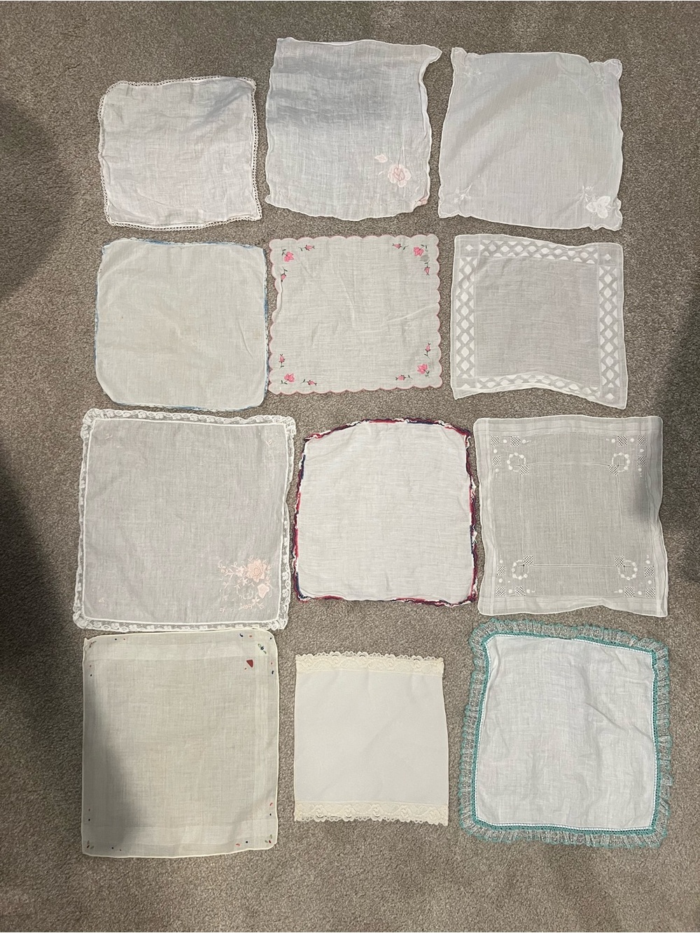 Bundle of vintage fabric handkerchiefs with lace, floral, and embroidered detail